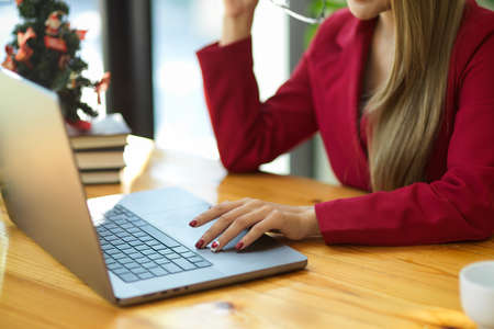 Cropped image of confident businesswoman working on laptop computer at her office desk.の写真素材
