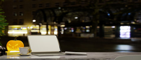 Laptop computer with copy space on a table over blurred the street at night in the background. 3d rendering, 3d illustrationの写真素材