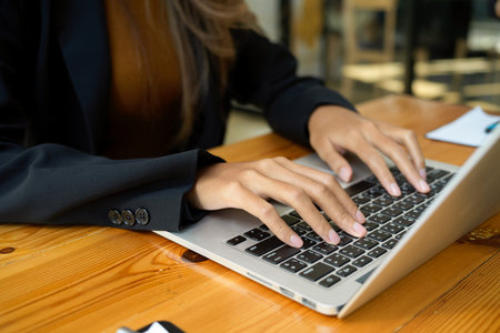Close-up image of a female worker using laptop computer. Business woman working on computer notebook.の写真素材