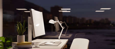 Side view, Modern office working space with computer desk near a large glass window of the building. Office studio interior. 3d rendering, 3d illustrationの写真素材