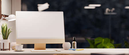Close-up computer desk with white monitor on modern desk and city night view in background. Office studio interior. 3d rendering, 3d illustrationの写真素材
