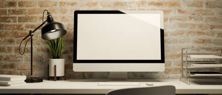 Modern desktop computer mockup with office supplies and decors on a desk over brick wall. 3d...