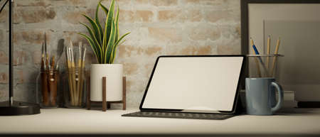 Modern workspace with digital tablet or touchpad mockup, painting tools,  stationery, decors on table over brick wall. 3d rendering, 3d illustrationの写真素材