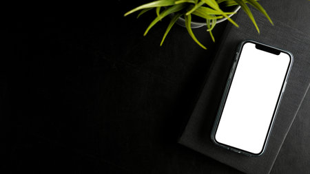 Smartphone white screen mockup and copy space for product display on black worktable. top view, flatの写真素材
