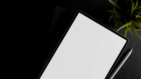 Digital touchpad white screen mockup for your graphic banner on black background. top view, flat layの写真素材