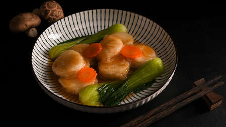 Braise bean curd with special asian sauce and vegetables in a porcelain plate. Asian food concept.の写真素材