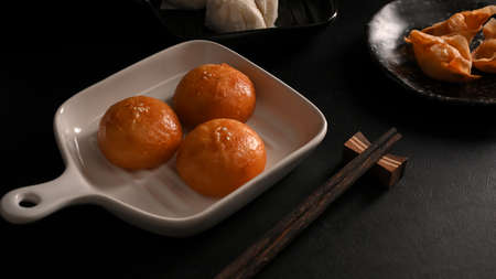 Fried buns, Traditional Chinese fried pork or cream buns in a plate and fried shrimp dumplings.