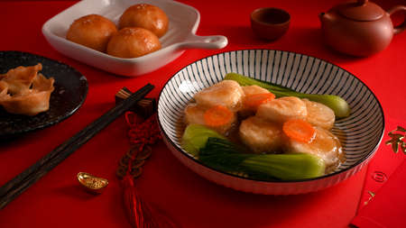 Yummy braise bean curd with sauce, Chinese fried pork buns, fried shrimp dumplings and tea sets on ding table. Traditional Chinese food.の写真素材