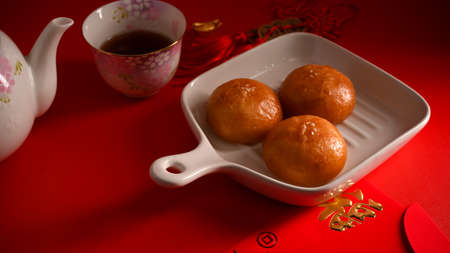 Original tasty Chinese fried buns on a plate and hot tea set. Chinese breakfast or appetizer concept. Translation: Fu meaning good fortuneの写真素材