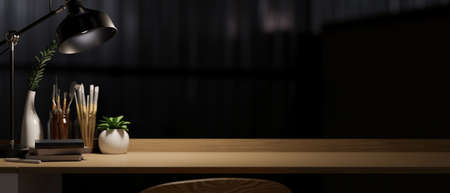 Modern dark workspace with painting tools, books, decor, table lamp and copy space on wooden desk over dark background. 3d rendering, 3d illustrationの写真素材