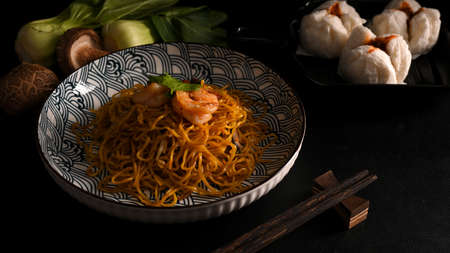 Delicious Chow mein with shrimp on a plate and steamed red bbq pork buns. Chinese cuisine conceptの写真素材