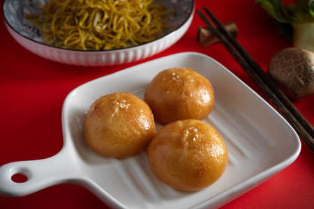 Traditional Chinese food, Fried pork or cream buns on a plate. Tasty Asian street food.の写真素材