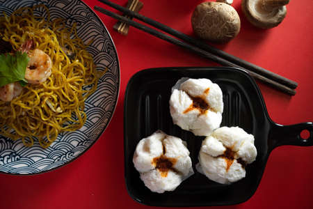 Chinese steamed pork bbq buns with chow mein or Chinese stir fried noodles. Asian food concept. Top-viewの写真素材