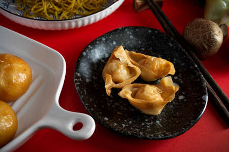 Close-up image, A traditional Chinese dining table setting with a plate fried shrimp dumplings. Asian foodの写真素材