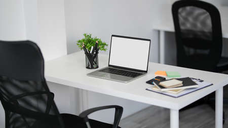 Modern and comfortable office workspace with laptop computer mockup, stationery, office supplies and...