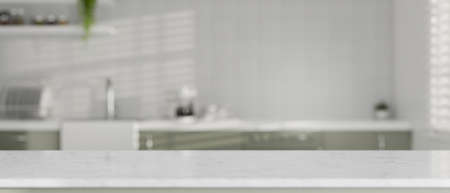 Copy space for montage product display on modern white granite kitchen countertop over modern contemporary kitchen room in the background. 3d rendering, 3d illustrationの写真素材