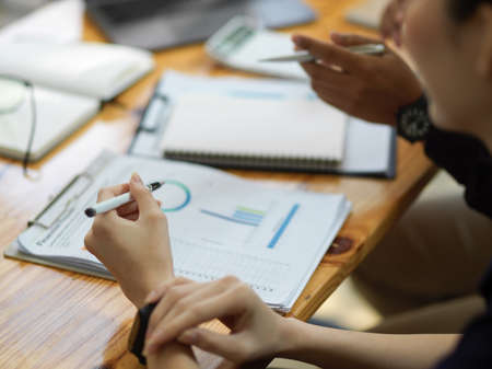 Cropped image of business team in the meeting, working and discussing together in the office...