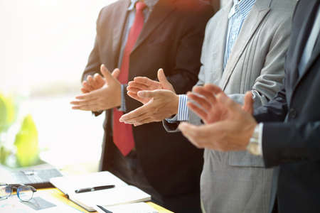 Group of a executive businessman standing and clapping theirs hands in the meeting room....