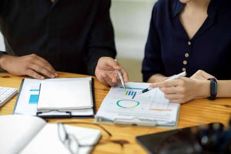 Professional financial male manager training his financial staff to analyse the data chart and graph...