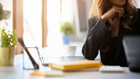 Cropped image of a Business woman thoughtful, pensive thinking or finding a creative ideas at her...