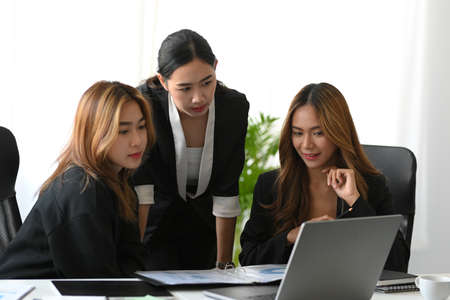 A group of an attractive asian businesswoman working together in the office. A female marketing team discussing their project.の写真素材
