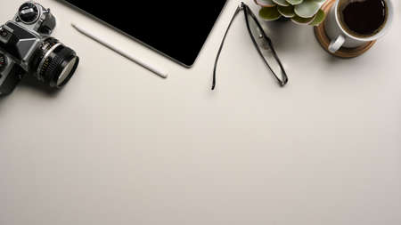 Copy space on white background or workspace with camera, tablet and supplies. Photographer or designer desk concept. Top viewの写真素材