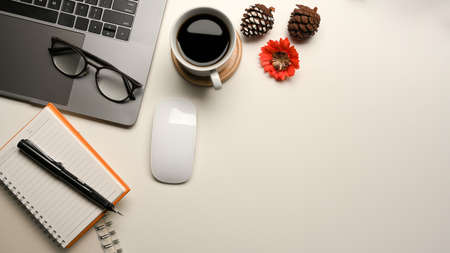 Simple workspace with copy space laptop computer, notebook, mouse, coffee cup and stuff.の写真素材