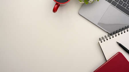 Simple Top view of worktable, office desk with laptop, notebooks and coffee cup on white background.