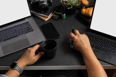 Professional businessman office desk with multiple devices screen. Laptop and tablet blank screen.の写真素材
