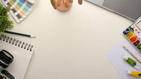 Creative artist students worktable with copy space on white background. photographer, designer workplace.の写真素材