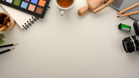 Graphic designer workplace top-view with essential work tools and copy space on white background.の写真素材