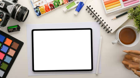Graphic designer office workstation with work equipment and digital tablet computer white display mockup. top viewの写真素材
