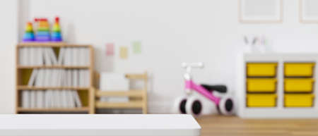 Modern baby kids playroom interior design with bookcase, bicycle and modern furniture. Copy space on tabletop over blurred playroom background. 3d rendering, 3d illustrationの写真素材