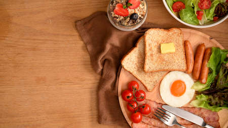 Healthy cuisine concept. Homemade breakfast set with salad bowl and yoghurt bowl on wooden table.の写真素材