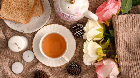 Concept of a feminine breakfast tea set,A set of afternoon tea, toasts, beautiful roses and cozy autumn composition decorations. flat lay, top viewの写真素材
