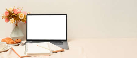 Stylish feminine workspace with laptop computer mockup, notebooks, decor and copy space on white table.の写真素材