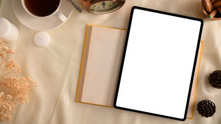 Female office workspace with modern digital tablet computer blank screen mockup for display your graphic. flat lay, top viewの写真素材