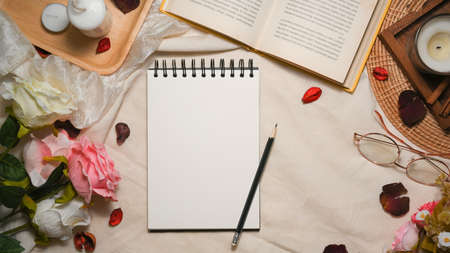 Empty spiral notepad paper for your text in feminine vintage workspace composition background. flatの写真素材