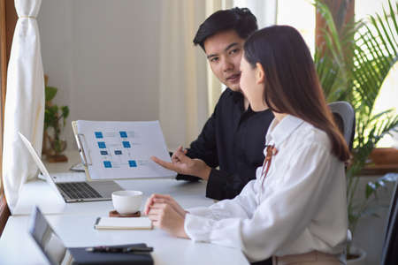 Business management team colleagues planning and analysing business strategy together in the office.