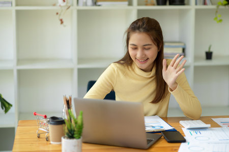 Female entrepreneur working in her home office and having an online meeting or online conference with her supplier team.の写真素材