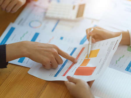 Cropped shot, A female financial consultant explain the investment plan and profit chart on the report to her business client.の写真素材