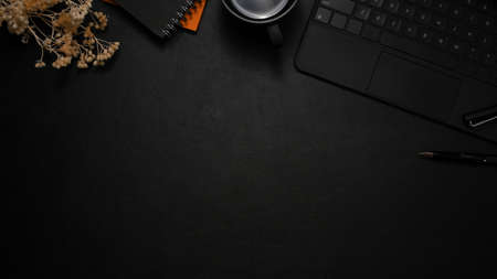 Modern black leather workspace with accessories, wireless keyboard and copy space. top viewの写真素材