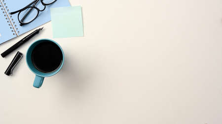 Top view workspace with blue accessories and copy space on white background. Study table and stationery conceptの写真素材