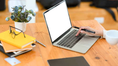 Close-up image, A professional businesswoman working on laptop computer, typing on keyboard, doing her online work at office space.の写真素材