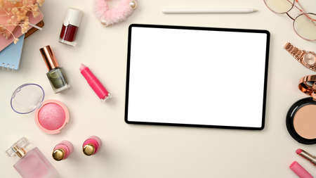 Beauty blogger or makeup artist workspace with digital tablet white screen mockup and cosmetics makeup on white background. top view, flat layの写真素材