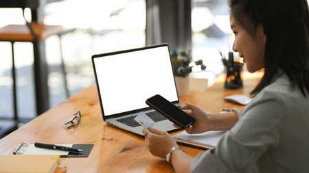 Close-up image, a female assistant typing a credit card number on smartphone and checking the balance on mobile application.の写真素材