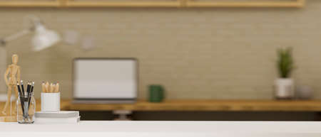 A modern white office desk with stationery, wooden figure and copy space for product display over...