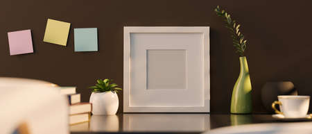 Blank picture photo frame mockup with home accessories, indoor plant and coffee cup on the table over brown wall background. 3d rendering, 3d illustrationの写真素材