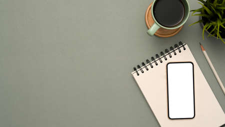 Overhead shot, Copy space on modern grey office workspace background with white screen smartphone...