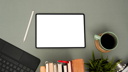 Minimal office desk workspace with digital tablet white display, coffee cup, stylus pen and accessories on grey background. top view, flat layの写真素材
